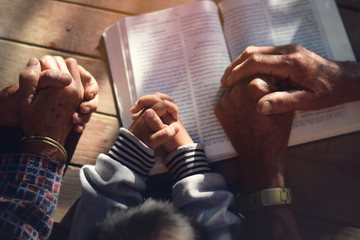 The boy prayed on the table. The family prayed together.