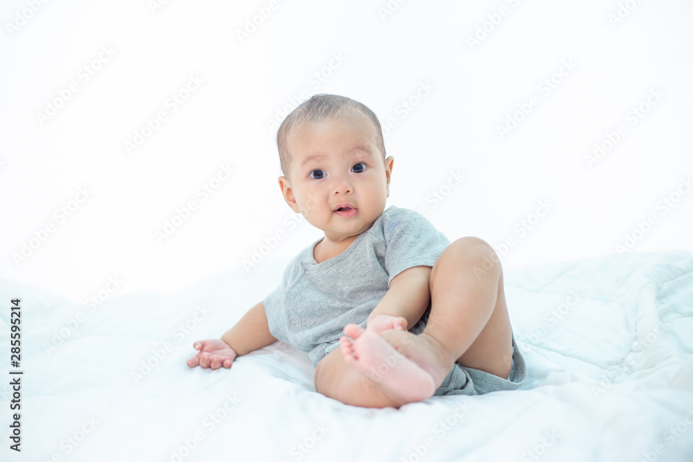 The little boy sitting on the bed The little boy sitting on the bed