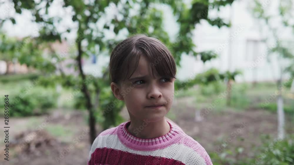 Flying Drone over Face portrait close up. Beautiful little girl looking at the camera. Furniture backgroundPark. Central city park, Slatina, Romania. 4k