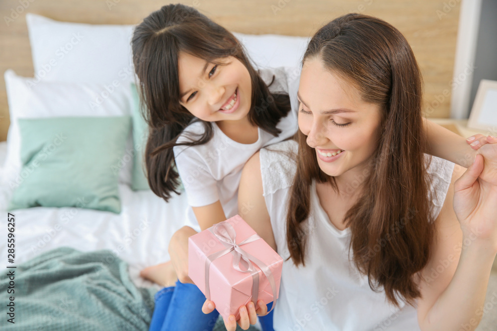 Little girl greeting her mother in bedroom Little girl greeting her mother in bedroom
