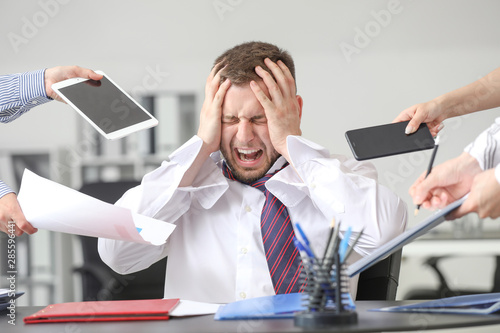 Overworked businessman havi...