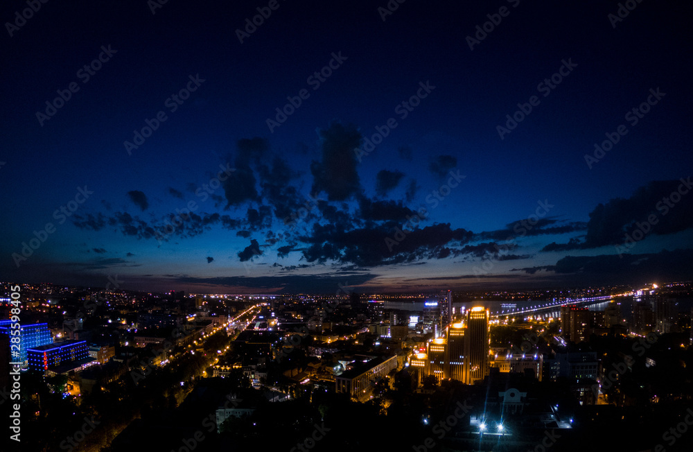 Amazing view on the night city lights and dark blue sky above, cityscape