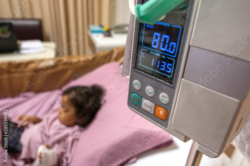 Infusion pumps with blurry kid in hospital.