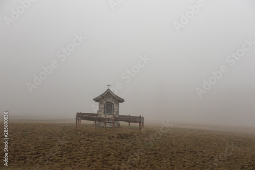 Fotografering The old chapel in a fog  Alps, Austria
