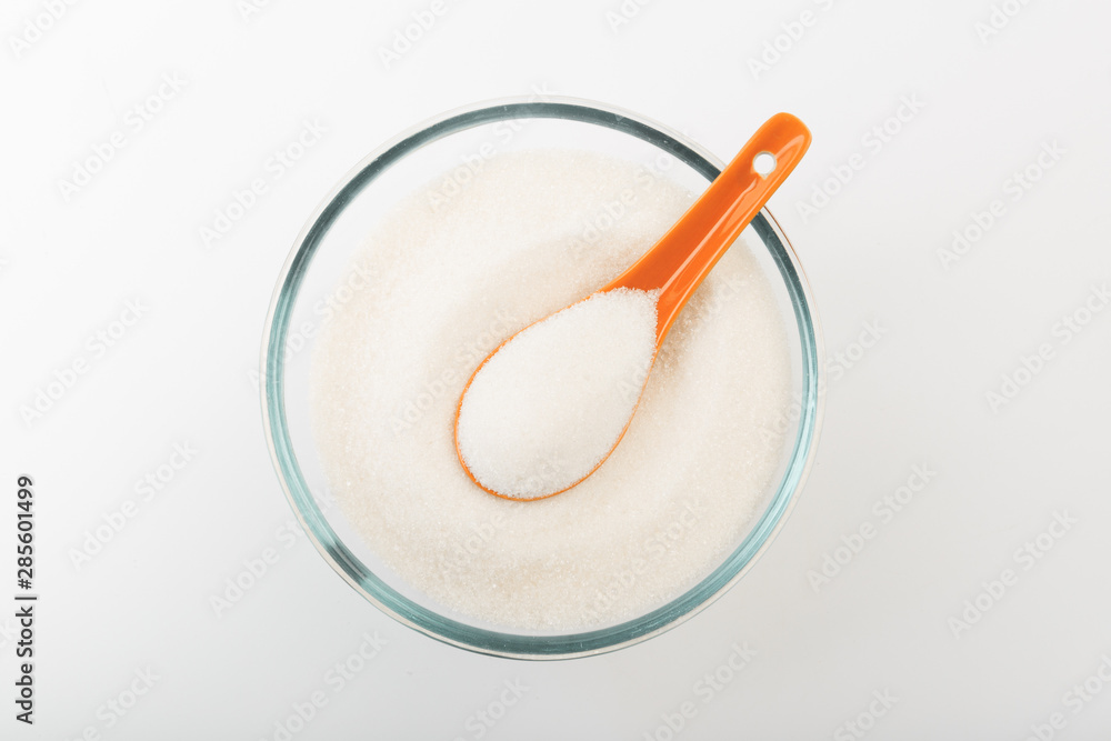 Sugar in glass bowl isolated on white background Sugar in glass bowl isolated on white background