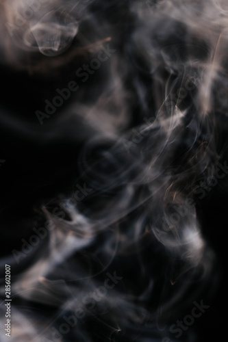 Brown wavy smoke on black background