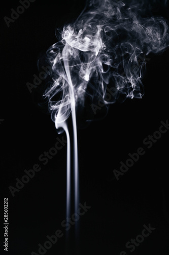 White wavy smoke on black background