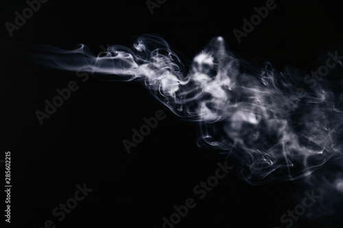 White wavy smoke on black background