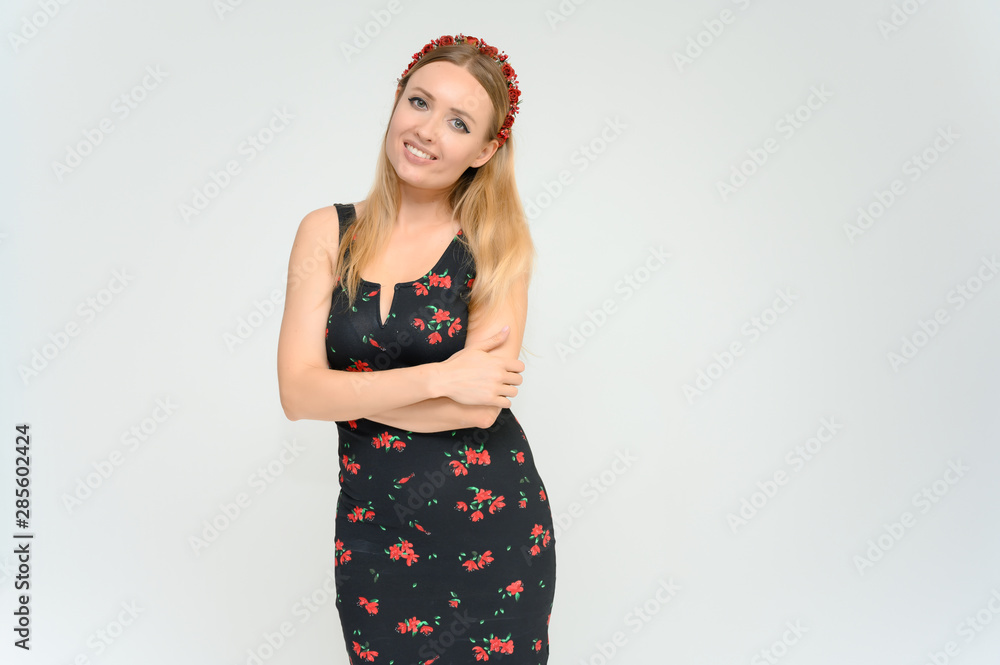 Studio portrait portrait of a pretty young happy blonde woman in a beautiful dress on a white background. He smiles, talks, shows with his hands, moves, shows emotions. Studio portrait portrait of a pretty young happy blonde woman in a beautiful dress on a white background. He smiles, talks, shows with his hands, moves, shows emotions.