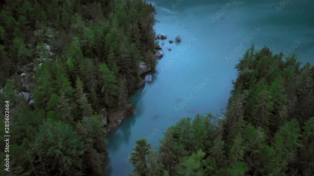 Aerial, rising, drone shot, tilting towards a reflecting, blue alpine pond, in a valley, between mountains, on a sunny, summer evening, at dusk, in the Swiss alps of Valais, Switzerland Aerial, rising, drone shot, tilting towards a reflecting, blue alpine pond, in a valley, between mountains, on a sunny, summer evening, at dusk, in the Swiss alps of Valais, Switzerland