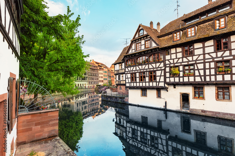 Beautiful travel landscape with half-timbered houses on the banks of the river ill and decorated flowers in Strasbourg. France and Europe tourist destination