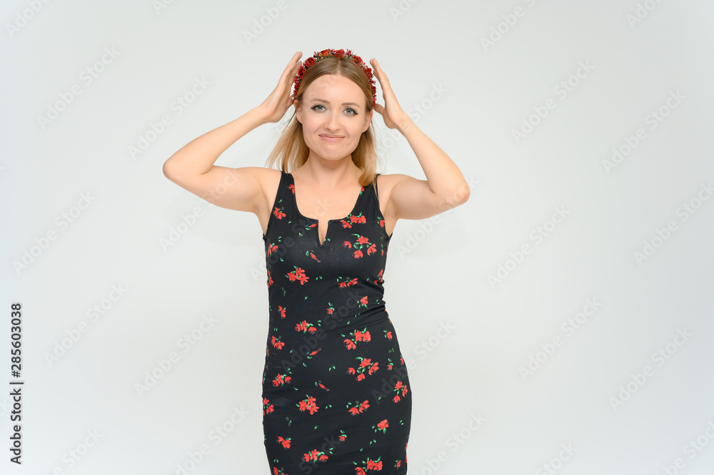 Studio portrait portrait of a pretty young happy blonde woman in a beautiful dress on a white background. He smiles, talks, shows with his hands, moves, shows emotions. Studio portrait portrait of a pretty young happy blonde woman in a beautiful dress on a white background. He smiles, talks, shows with his hands, moves, shows emotions.