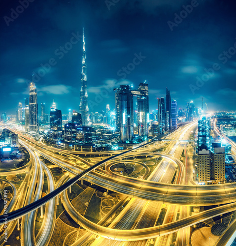 Canvas Print Dubai at night. Scenic aerial view on highways and skyscrapers.