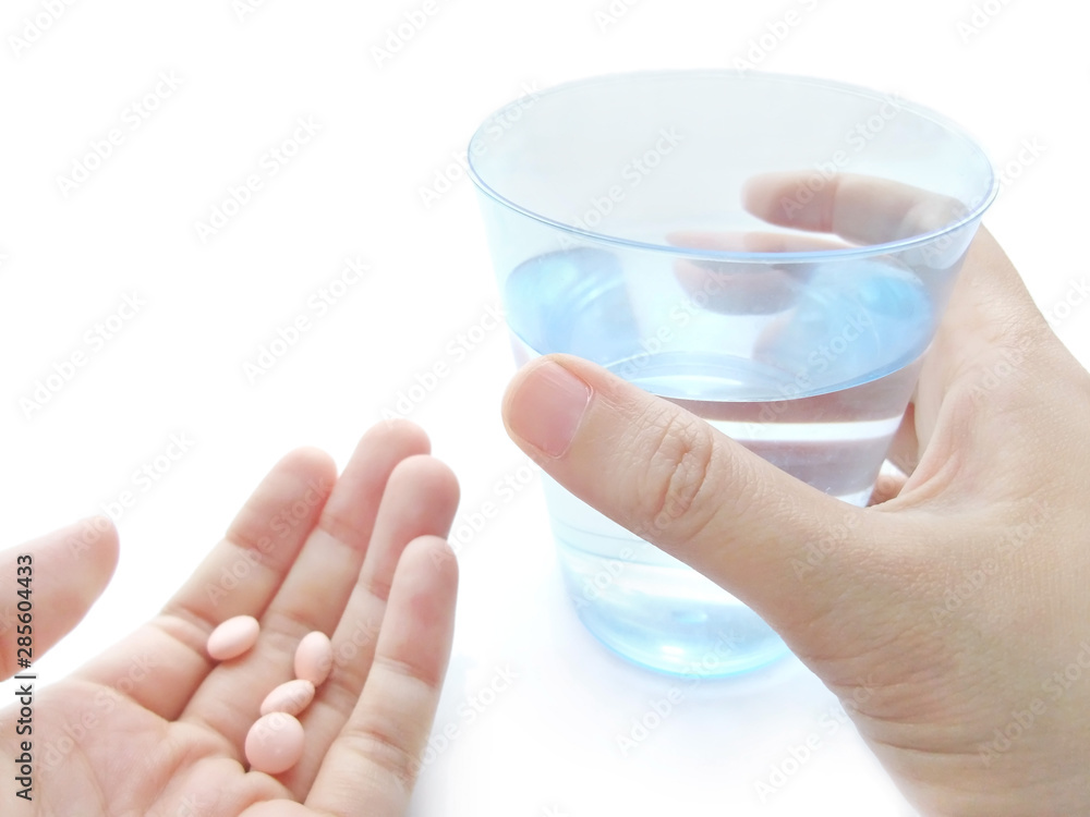 手に持った錠剤と水 手に持った錠剤と水