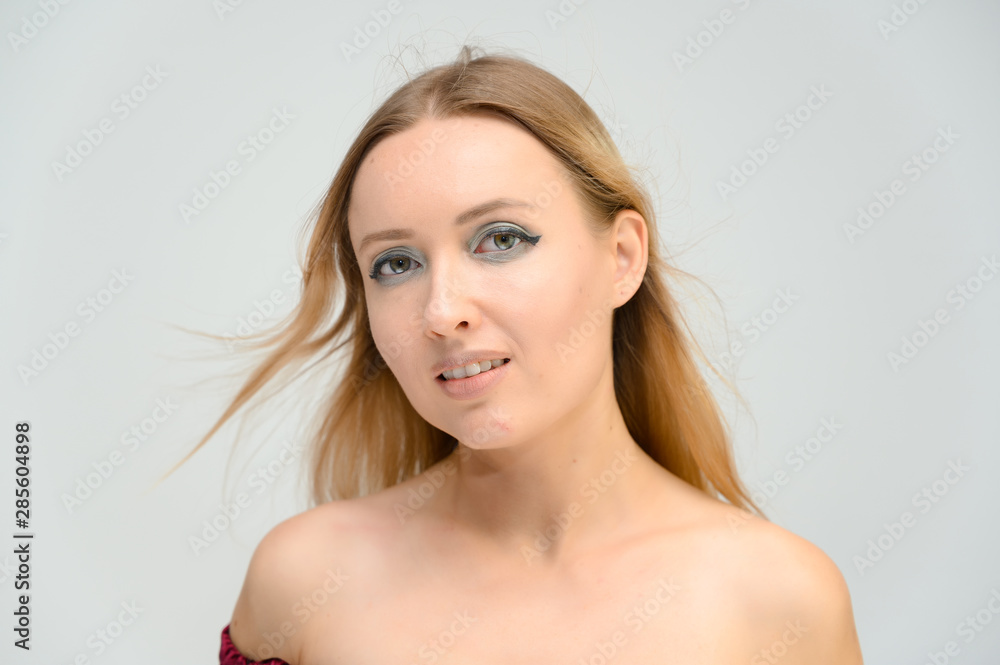 Studio closeup photo portrait of a pretty beautiful young happy blonde woman on a white background with beautiful makeup and good skin. Smiling, showing emotions. Studio closeup photo portrait of a pretty beautiful young happy blonde woman on a white background with beautiful makeup and good skin. Smiling, showing emotions.