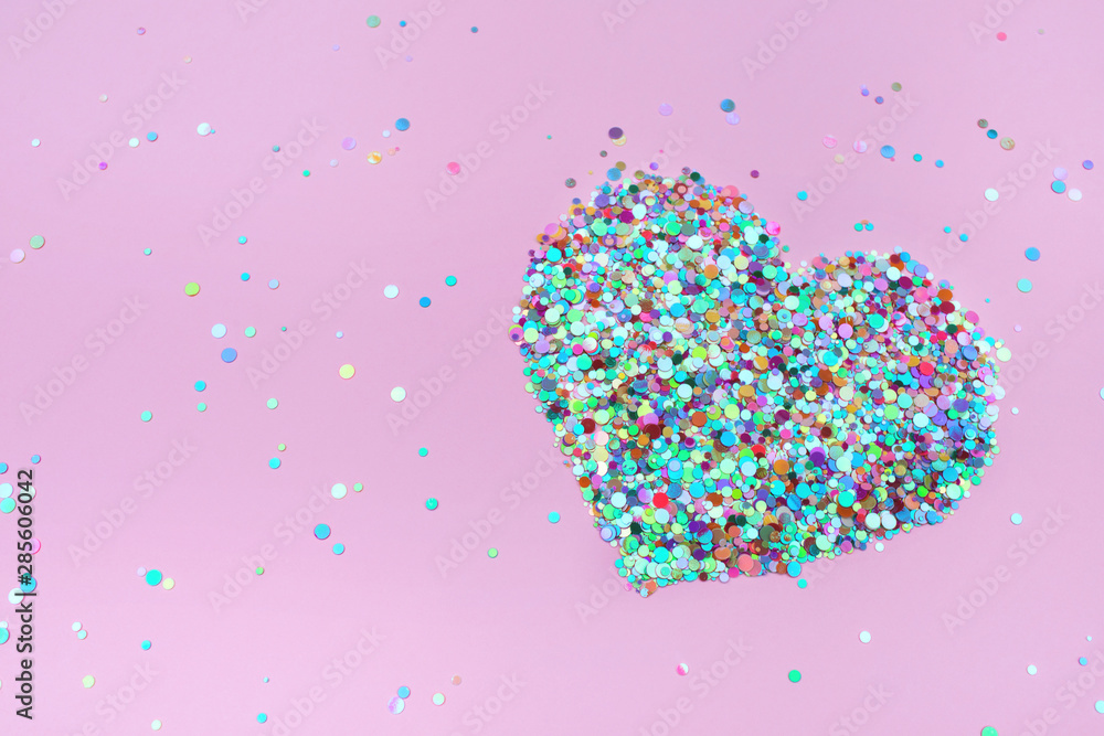 Confetti hearts on pink background. Copy space, top view. Valentine's Day concept.