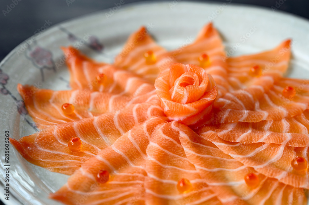 Slices of raw Salmon sashimi on dish Slices of raw Salmon sashimi on dish