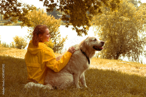 Woman Tenderly Hugging Pet Dog. Autumn colors photo