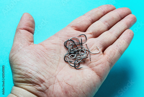 fishing hooks hold in the palm of the open.hooks beardless photo