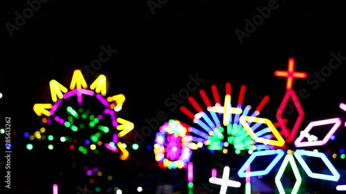 multi color of rooling neon and ferris wheel light in night market fair photo