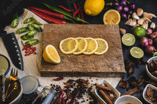 Wallpaper Mural Healthy food herbs. Spices for use as cooking ingredients on a wooden table with Fresh organic vegetables and raw material with Variety on the rustic table. Sliced ​​lemon on a wooden cutting board. Torontodigital.ca