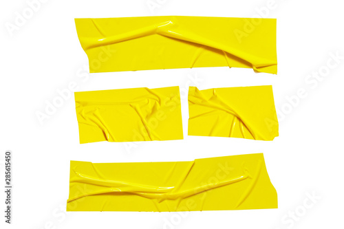Yellow sticky scotch tapes. Torn crumpled sellotape pieces set isolated on white background photo