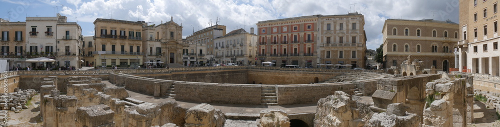 Lecce –  St Oronzo Square. It includes :  the Roman amphitheater ; the St Oronzo Column ; the Sedile palace was the ancient seat of the Town Hall ; St Mark Church ; Bank of Italy palace