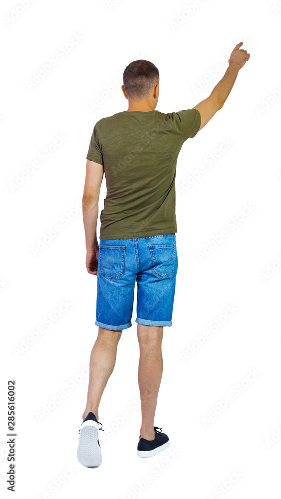Back view of going pointing man in shorts. Back view of going pointing man in shorts.