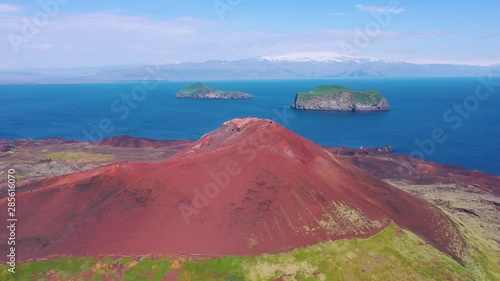 Good aerial of Eldfell volcano looming over Heimaey in the Westman Islands, Vestmannaeyjar, Iceland.  photo