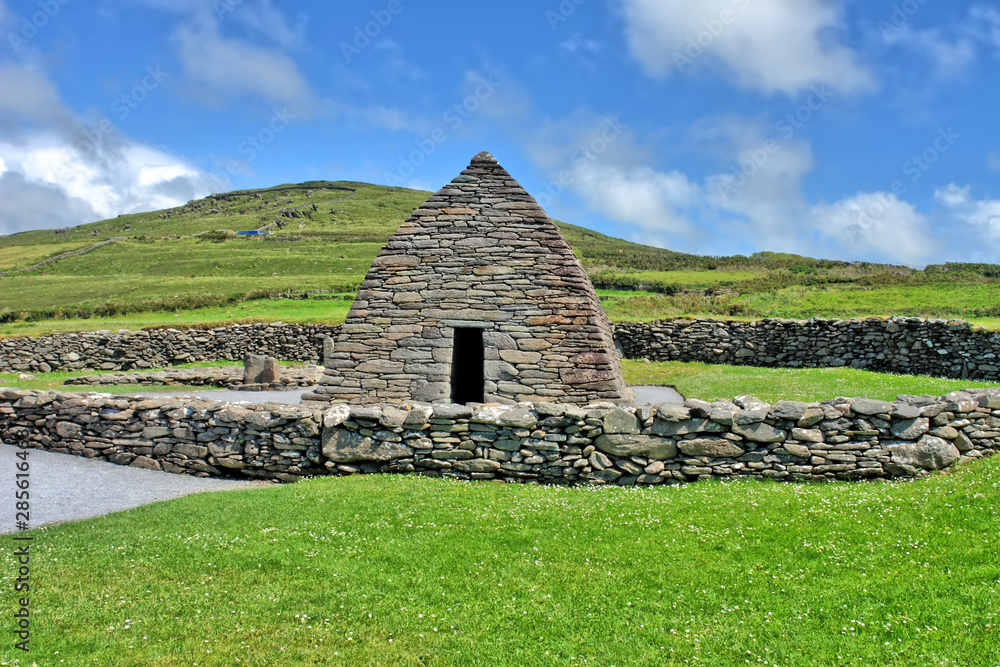 The Gallarus Oratory in sunshine - a chapel located on the Dingle Peninsula, County Kerry, Ireland. The Gallarus Oratory in sunshine - a chapel located on the Dingle Peninsula, County Kerry, Ireland.
