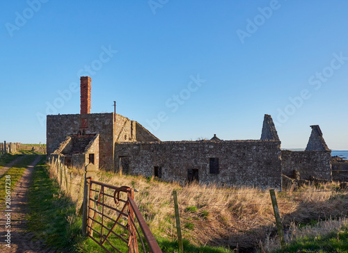 Derelict and Abandoned Farm Cottages and Buildings at Usan on the East Coast of Scotland, near Montrose in the early morning light on a Spring Day. photo