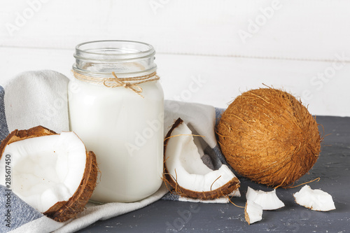 Coconut and  glass of coconut milk on  wooden background