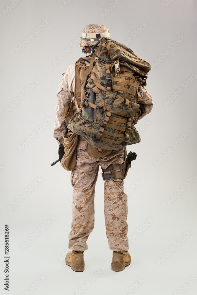 Portrait of a young American US Marine Corps soldier over grey background Portrait of a young American US Marine Corps soldier over grey background