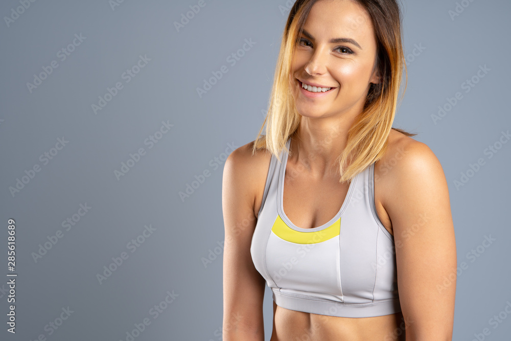 Young sporty fit caucasian female model on gray background Young sporty fit caucasian female model on gray background