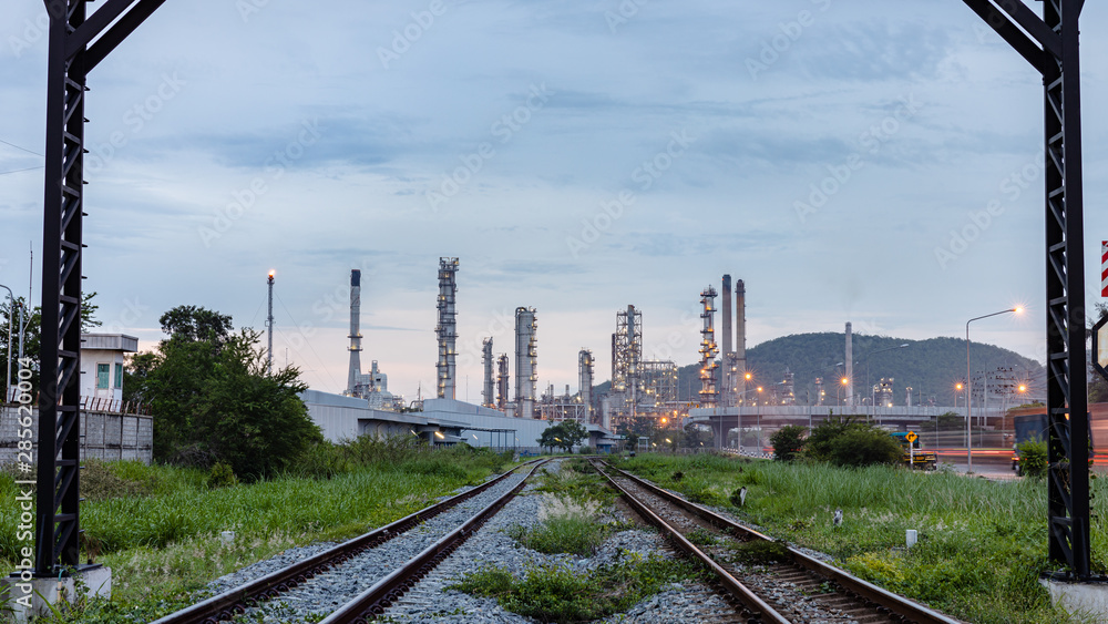 industrial oil and gas production plant with the foreground railroad at evening