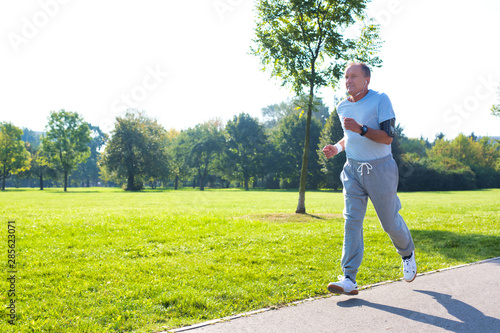 Active senior man running in park