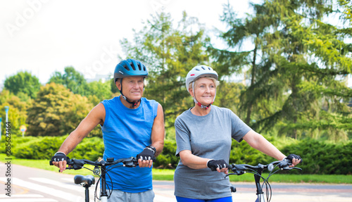 Wallpaper Mural Fit senior couple walking with bicycle in park Torontodigital.ca