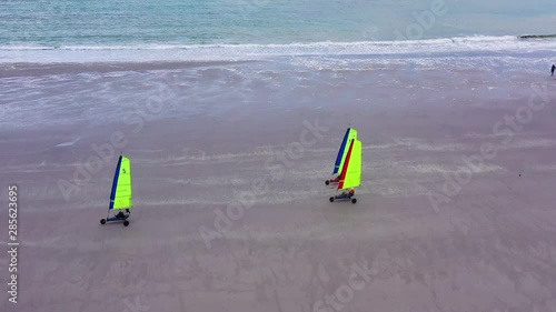 Aerial land carts sail carts blokarts sand yachts are sailed on the beach in France. photo