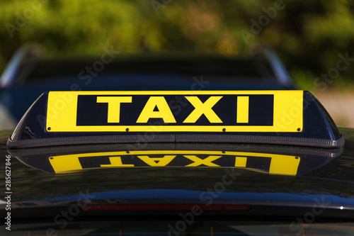 Taxi sign on roof of black cab