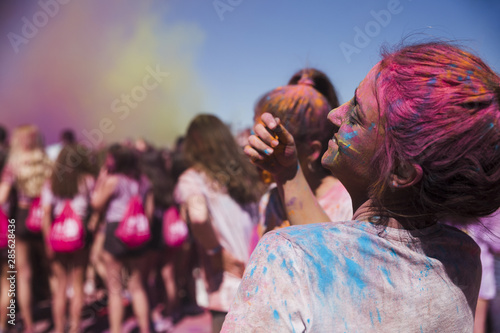 Rear view of a young woman playing with holi powder