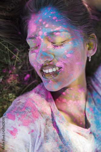 Close-up of holi color on woman's face