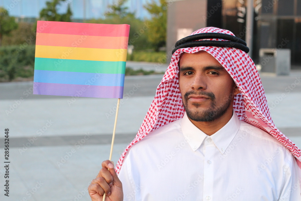 Attractive Arabic gay man holding the rainbow flag Stock Photo | Adobe Stock