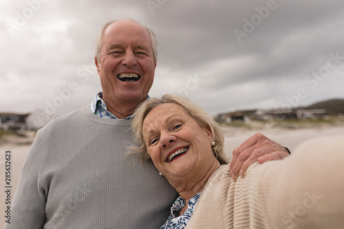 Happy senior couple having fun at the beach 