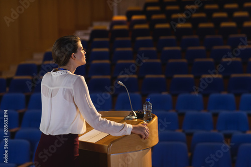 Businesswoman practicing for speech in the empty auditorium