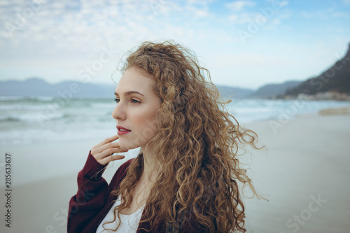 Beautiful woman standing at beach 