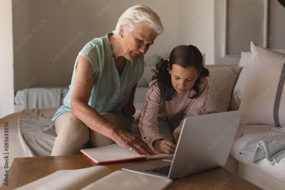 Grandmother helping her granddaughter with homework Grandmother helping her granddaughter with homework