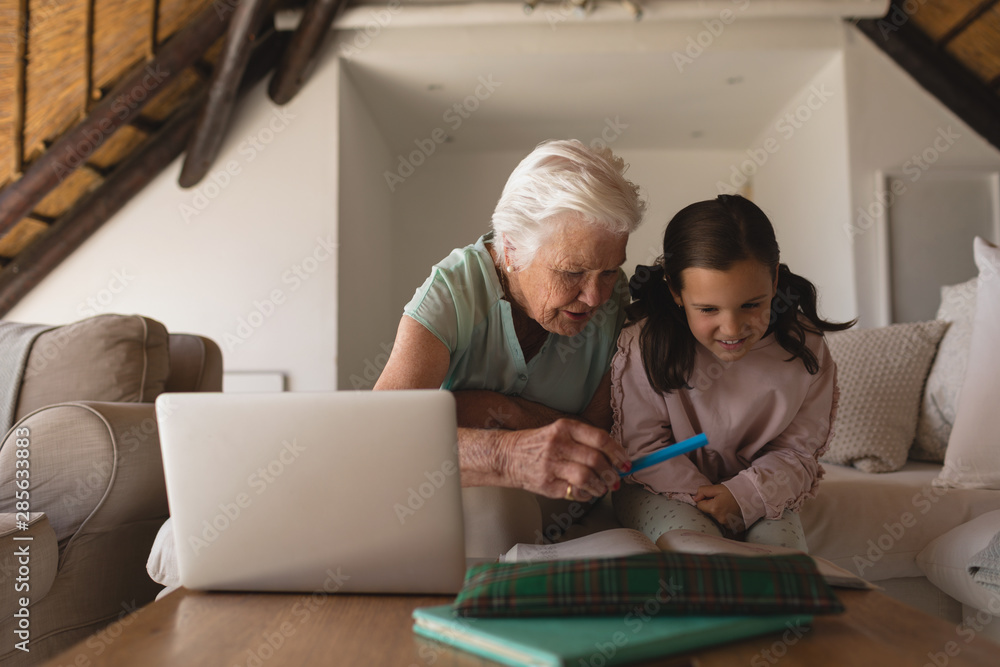 Grandmother helping her granddaughter with homework Grandmother helping her granddaughter with homework