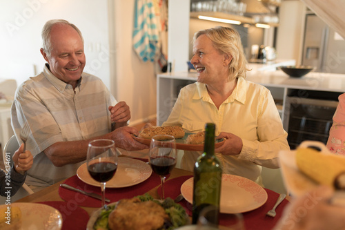 Senior couple interacting with each other on dining table
