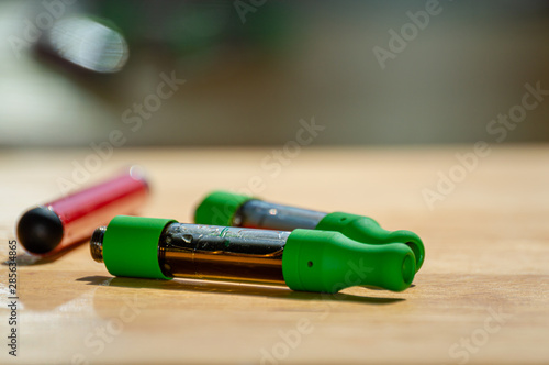 Marijuana vape kit with red vape pen and THC CBD oil cartridges.
