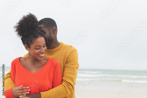 Couple standing at beach on a sunny day